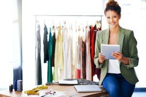 Shot of a fashion designer using her digital tablet at work
